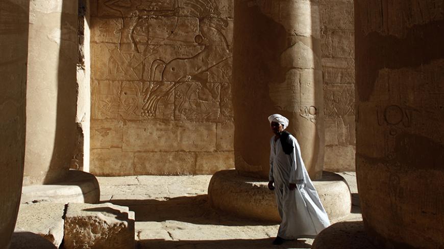 A local Egyptian man, employed as a guardian to help oversee the site, stands in Ramses II memorial temple in Luxor December 4, 2008. Ramses II was a 19th dynasty pharaoh who ruled Ancient Egypt for 67 years during the 13th century B.C.   REUTERS/Goran Tomasevic      (EGYPT) - RTR229Q8