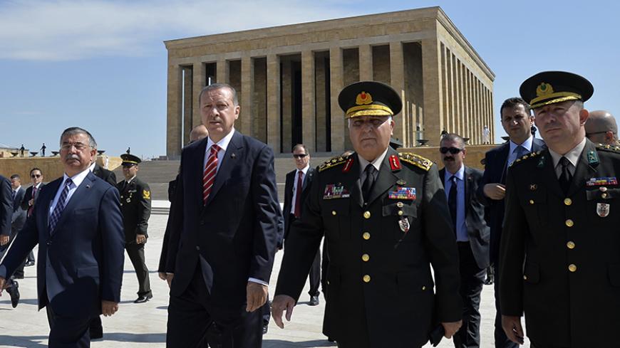 Turkey's Prime Minister Tayyip Erdogan (2nd L), flanked by Chief of Staff General Necdet Ozel (2nd R) and Defence Minister Ismet Yilmaz (L), leaves after a wreath-laying ceremony with members of the High Military Council at Anitkabir, the mausoleum of modern Turkey's founder Mustafa Kemal Ataturk, ahead of a High Military Council meeting in Ankara August 4, 2014. REUTERS/Stringer (TURKEY - Tags: POLITICS MILITARY) - RTR415KJ