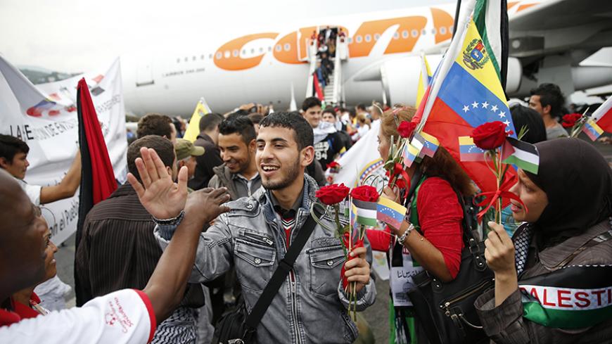 Palestinian students arrive at Simon Bolivar airport outside Caracas November 6, 2014. Some one hundred Palestinian students arrived in Caracas on Thursday to begin their studies in medicine at a medical school in Caracas.   REUTERS/Jorge Silva    (VENEZUELA - Tags: POLITICS EDUCATION) - RTR4D61U