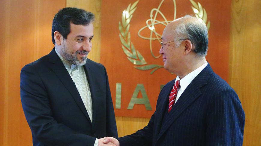 International Atomic Energy Agency (IAEA) Director General Yukiya Amano (R) welcomes Iran's chief nuclear negotiator Abbas Araghchi in his offfice at the IAEA headquarters in Vienna February 24, 2015. REUTERS/Heinz-Peter Bader (AUSTRIA - Tags: POLITICS ENERGY) - RTR4QWK7