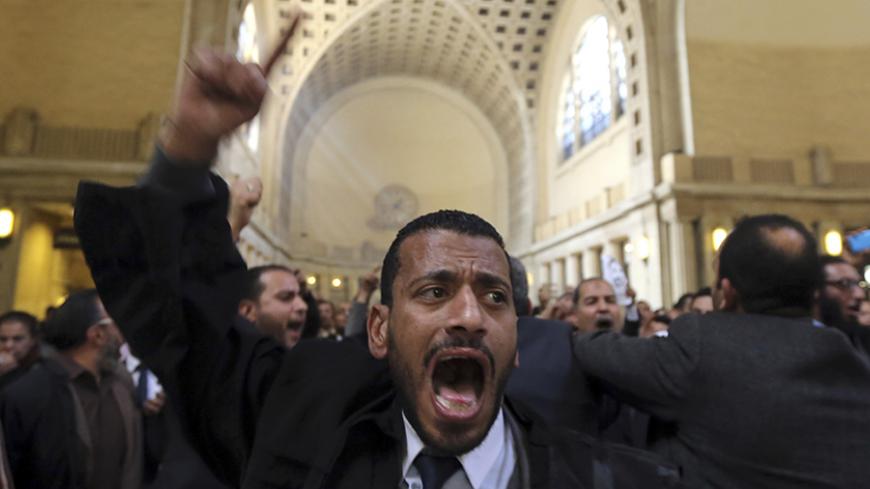 Lawyers shout slogans against the Interior Ministry during a protest at the high court headquarters in Cairo, March 1, 2015, after the death of lawyer Karim Hamdy in the Police Department last week. Two Egyptian policemen accused of killing a lawyer in custody were detained on Thursday on the orders of an Egyptian prosecutor, judicial sources said, a rare action against members of the security forces. REUTERS/Mohamed Abd El Ghany (EGYPT - Tags: POLITICS CIVIL UNREST) - RTR4RMKN