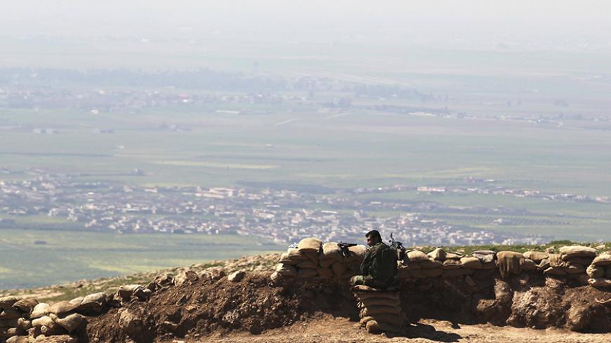 A member of the Kurdish Peshmerga forces guards a security point on Bashiqa mountain, overlooking Islamic State held territories of Mosul, 12 km northeast of Mosul City, March 7, 2015.  REUTERS/Asmaa Waguih (IRAQ - Tags: POLITICS MILITARY CONFLICT) - RTR4SF1D