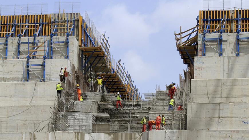 Construction workers are seen in a section of Ethiopia's Grand Renaissance Dam, as it undergoes construction, during a media tour along the river Nile in Benishangul Gumuz Region, Guba Woreda, in Ethiopia March 31, 2015. According to a government official, the dam has hit the 41 percent completion mark. Picture taken March 31, 2015. REUTER/Tiksa Negeri  - RTR4VQ4C