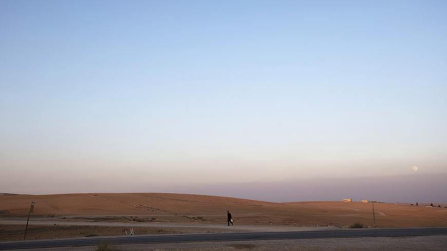A man walks near the village of al-Sira, one of dozens of ramshackle Bedouin Arab communities in the Negev desert which are not recognised by the Israeli state, in southern Israel August 20, 2013. For decades Arab Bedouins have eked out a meagre existence in the Negev desert, largely under the Israeli government's radar, but now many will have to make way for new developments. Israel has already invested around $5.6 billion to build military bases in the Negev desert and plans to build 10 new communities th