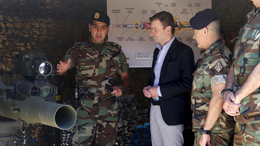 A Lebanese army soldier speaks to U.S. ambassador to Lebanon David Hale (2nd L) during a demonstration of TOW-II missiles, which were donated by the U.S. government to the Lebanese army, in the Taybeh range in Baalbek June 10, 2015. REUTERS/Mohamed Azakir
 - RTX1FXLQ