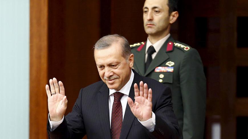 Turkey's President Tayyip Erdogan greets parliamentarians as he arrives at the Turkish parliament to watch a swearing-in ceremony in Ankara, Turkey, June 23, 2015 REUTERS/Umit Bektas  - RTX1HQAX