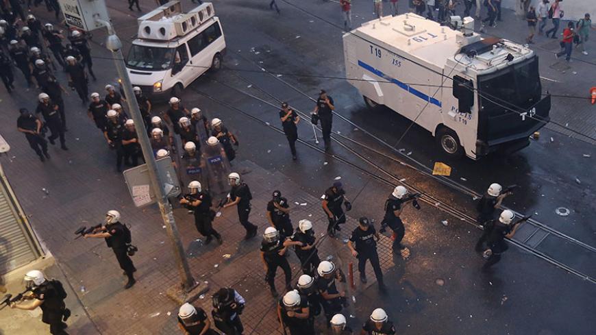 Riot police chase demonstrators during a protest in central Istanbul, Turkey, July 20, 2015. Police in Istanbul fired teargas and water cannon when a demonstration by protesters blaming the government for a suspected Islamic State suicide bombing turned violent, a Reuters witness said. Hundreds gathered near Istanbul's central Taksim Square after the bombing in the mostly Kurdish border town of Suruc which killed at least 30 people. Some chanted slogans against President Tayyip Erdogan and the ruling AK Par
