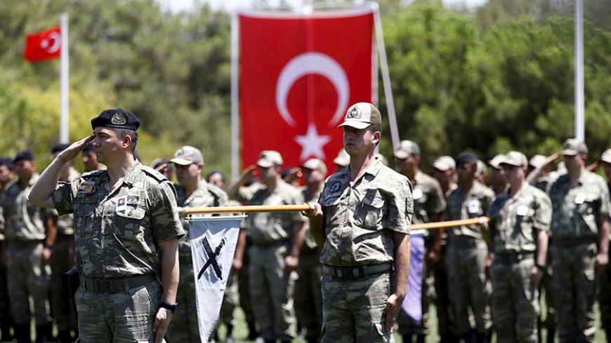 Turkish soldiers stand at attention during a ceremony for their comrade Mehmet Yalcin Nane who was killed by Islamic State militants on Thursday, at a military base in Gaziantep, Turkey, July 24, 2015. Turkish warplanes pounded Islamic State targets in Syria and police detained hundreds of suspected militants across Turkey on Friday, a sign that Ankara may have shed its hesitancy in taking a front-line role against jihadist fighters. Turkey has long been a reluctant partner in the U.S.-led coalition against