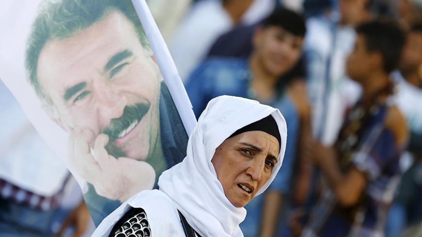 A demonstrator holds a portrait of Kurdistan Workers Party (PKK)'s jailed leader Abdullah Ocalan during a march in solidarity with him in Diyarbakir, Turkey, August 1, 2015.  REUTERS/Umit Bektas - RTX1MOBH