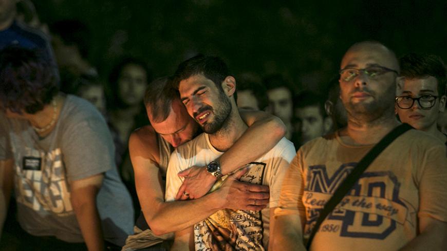 People react during a candlelight vigil in Tel Aviv, Israel, for Shira Banki, who died on Sunday of stab wounds sustained when an ultra-Orthodox man with a knife attacked a Gay Pride parade in Jerusalem three days ago, August 2, 2015. High school student Banki, 16, was one of six people wounded in the assault. Her death highlighted the city's sharp social divisions between Orthodox and secular Jews. REUTERS/Baz Ratner - RTX1MRMX