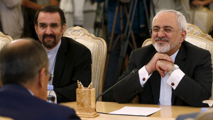 Iranian Foreign Minister Mohammad Javad Zarif (R) listens to his Russian counterpart Sergei Lavrov (back facing) during their meeting in Moscow, Russia, August 17, 2015. Lavrov and Zarif met on Monday to discuss the Iranian nuclear programme and peace efforts in Syria, Russia's foreign ministry said. Moscow sees the recent nuclear deal, which offers Iran relief from sanctions in exchange for curbing its nuclear programme, as opening the way to selling Tehran missile defence systems and winning lucrative new