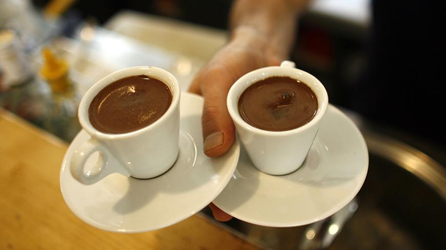 A waiter carries two cups of Turkish coffee at a coffee shop in Istanbul October 19, 2007. Turks are turning their backs on traditional Turkish coffee as they acquire a taste for the cappuccinos and espressos served at global coffee chain outlets opening up across this economically booming Muslim country. Picture taken October 19, 2007. To match feature TURKEY-COFFEE      REUTERS/Osman Orsal   (TURKEY) - RTX7D