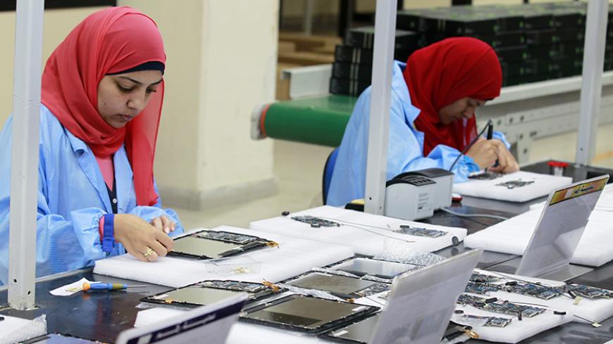 Workers are seen during the manufacturing process for Egypt's first tablet computer "Inar" at a factory in Benha May 18, 2013. Egypt has produced its very first tablet computer "Inar", part of a national project to distribute the device to students in schools and universities around the country. The Ministry of Military Production in collaboration with the Ministry of Communications presented the scheme last year to Benha Electronics Company known as 'Katron' to manufacture the tablet. Picture taken May 18,