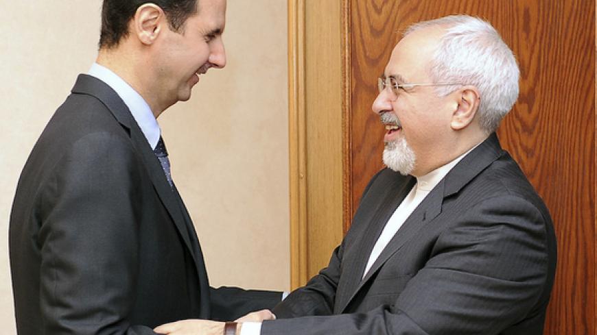 Syria's President Bashar al-Assad (L) welcomes Iran's Foreign Minister Mohammad Javad Zarif before a meeting in Damascus January 15, 2014, in this handout released by Syria's national news agency SANA. REUTERS/SANA/Handout via Reuters (SYRIA - Tags: POLITICS CONFLICT TPX IMAGES OF THE DAY) ATTENTION EDITORS - THIS IMAGE WAS PROVIDED BY A THIRD PARTY. FOR EDITORIAL USE ONLY. NOT FOR SALE FOR MARKETING OR ADVERTISING CAMPAIGNS. THIS PICTURE WAS PROCESSED BY REUTERS TO ENHANCE QUALITY. AN UNPROCESSED VERSION W