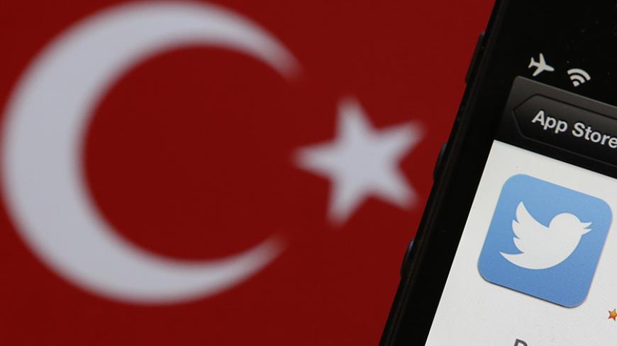 A Twitter logo on an iPhone display is pictured next to a Turkish flag in this photo illustration taken in Istanbul March 21, 2014. Turkey's courts have blocked access to Twitter a little over a week before elections as Prime Minister Tayyip Erdogan battles a corruption scandal that has seen social media awash with alleged evidence of government wrongdoing. The ban came hours after a defiant Erdogan, on the campaign trail ahead of key March 30 local elections, vowed to "wipe out" Twitter and said he did not