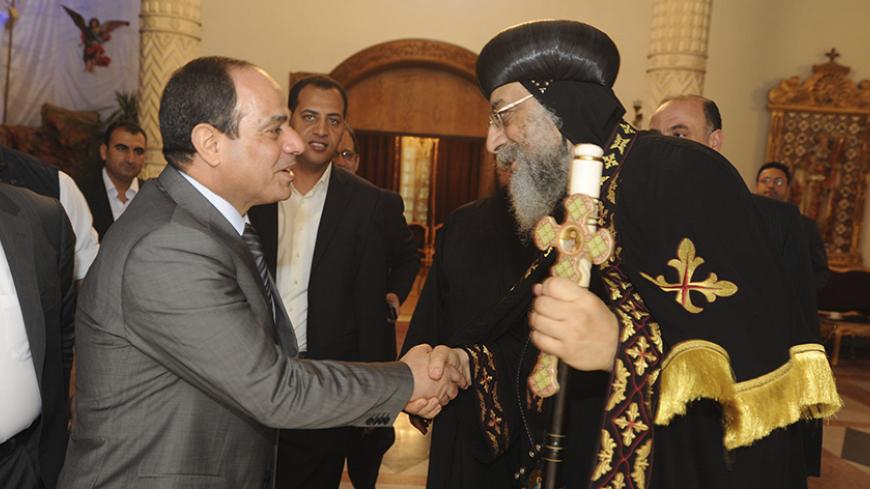 Coptic Pope Tawadros II, head of the Coptic Orthodox Church, shakes hands with former army-chief Abdel Fattah al-Sisi upon Sisi's arrival for a visit the night before Easter, in Cairo, April 19, 2014.     REUTERS/Al Youm Al Saabi Newspaper   (EGYPT - Tags: POLITICS RELIGION) EGYPT OUT. NO COMMERCIAL OR EDITORIAL SALES IN EGYPT - RTR3LWBX