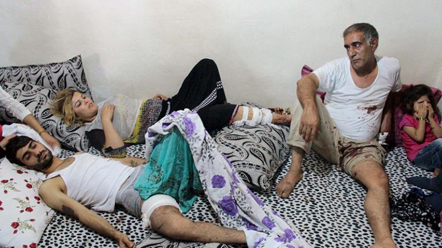 Wounded residents rest at a home in the southeastern town of Cizre in Sirnak province, Turkey, September 12, 2015. In the town of Cizre, scene of intense clashes between the Kurdistan Workers Party (PKK) and the Turkish army, residents ventured out to stock up on groceries and check on their shops after authorities lifted a nine-day round-the-clock curfew at 7 a.m. (0400 GMT), residents said. REUTERS/Sertac Kayar  - RTSRC2