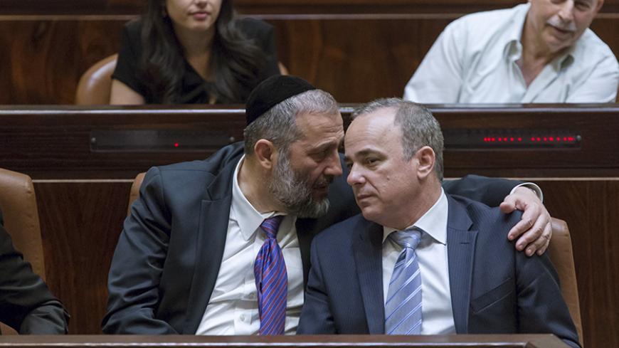 Israel's new Economy Minister and leader of the Ultra-Orthodox Shas party, Aryeh Deri (L), speaks to Yuval Steinitz, the new energy minister, during a swearing-in ceremony at the Knesset, the Israeli  parliament, in Jerusalem May 14, 2015. Israeli Prime Minister Benjamin Netanyahu's new rightist coalition government, hobbled from the outset by its razor-thin parliamentary majority, was sworn in late on Thursday amid wrangling within his Likud party over cabinet posts. Picture taken May 14, 2015. REUETRS/Jim