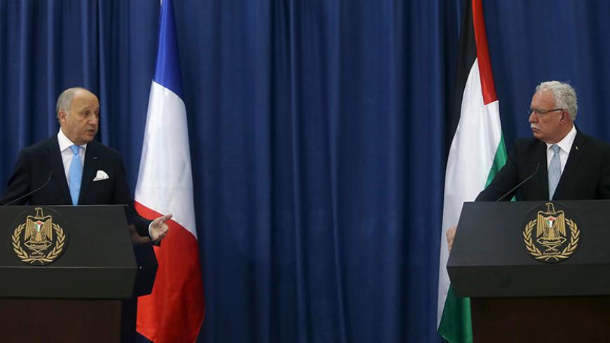 France's Foreign Minister Laurent Fabius (L) attends a joint news conference with Palestinian Foreign Minister Riyad al-Maliki in the West Bank city of Ramallah June 21, 2015. Prime Minister Benjamin Netanyahu prefaced talks about a French-led peace initiative on Sunday by saying foreign powers were trying to dictate to Israel a deal with the Palestinians. Fabius, on a two-day visit to the Middle East, met Palestinian leaders in the occupied West Bank before seeing Netanyahu later in the day.   REUTERS/Moha