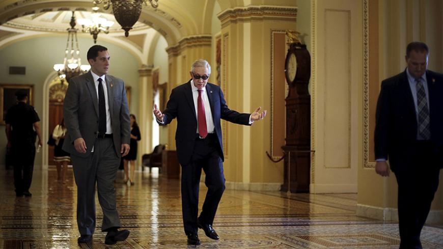 U.S. Senate Minority Leader Harry Reid (D-NV) (C) walks to his office as he arrives at the U.S. Capitol in Washington September 8, 2015. Reid, the Democratic leader in the U.S. Senate, issued a ringing defense of the Iran nuclear deal on Tuesday, saying the agreement would survive the high stakes review by Congress.  REUTERS/Jonathan Ernst - RTX1RNSH