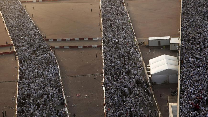 Muslim pilgrims walk on roads as they head to cast stones at pillars symbolizing Satan during the annual haj pilgrimage in Mina on the first day of Eid al-Adha, near the holy city of Mecca September 24, 2015. REUTERS/Ahmad Masood - RTX1S609