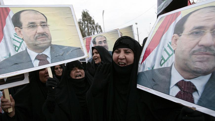 Supporters of Iraqi Prime Minister Nuri al-Maliki hold his portrait outside al-Dawa party's headquarters as they celebrate his return to Baghdad, 05 January 2008. Maliki arrived home today a week after flying to Britain for medical tests, saying in a newspaper interview he was determined to bring about reconciliation in the deeply divided country.  AFP PHOTO / AHMAD AL-RUBAYE (Photo credit should read AHMAD AL-RUBAYE/AFP/Getty Images)