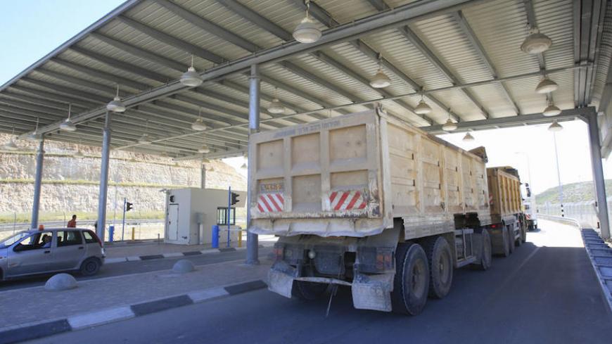 A lorry passes through the Israeli Tarqumiya checkpoint in the occupied West Bank near the town of Hebron on March 24, 2008. As of last year all goods coming arriving or leaving the southern West Bank pass through the thorough security checks at Tarqumiya checkpoint. AFP PHOTO/MEHDI FEDOUACH (Photo credit should read MEHDI FEDOUACH/AFP/Getty Images)
