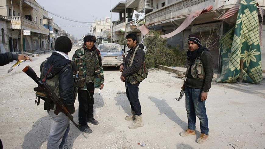 Fighters of the Kurdish People's Protection Units (YPG) patrol in the streets of the northern Syrian town of Kobani January 28, 2015. Kurdish forces battled Islamic State fighters outside Kobani on Tuesday, a monitoring group said, a day after Kurds said they had taken full control of the northern Syrian town following a four-month battle. Known as Ayn al-Arab in Arabic, the mainly Kurdish town close to the Turkish border has become a focal point in the international fight against Islamic State, an al Qaeda