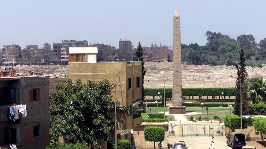 A red granite obelisk towering above a ramshackle, squalid suburb of
northeast Cairo, is the last visible vestige of a nearly 7,000-year-old
city where ancient Egyptians believed life began. Archaeologists say
they soon expect to unearth other artefacts and unlock the secrets of
the sun-cult city of On buried beneath today's suburbs of Ain Shams,
which means "eye of the sun" in Arabic, and the adjacent area of
Matariya. Picture taken August 9, 2002. TO GO WITH FEATURE
BC-LIFE-EGYPT-ARCHAEOLOGY REUTERS/Aladi
