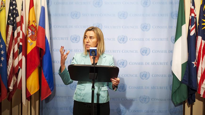 European Union Foreign Policy Chief Federica Mogherini speaks during a news conference in front of flags representing the countries of the United Nations Security Council at the United Nations headquarters in Manhattan, New York September 30, 2015. REUTERS/Darren Ornitz  - RTS2IDJ