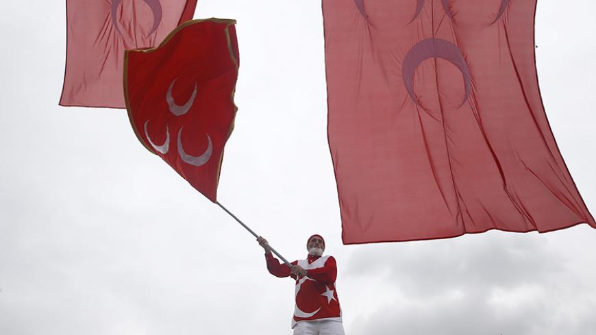 A supporters of the Nationalist Movement Party (MHP), waves the party flag during an election rally for Turkey's general election on November 1, in Istanbul, Turkey October 18, 2015.  REUTERS/Osman Orsal - RTS4Z02