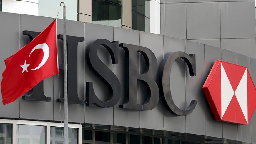 A Turkish flag flies at the HSBC headquarters in Istanbul, Turkey, June 9, 2015. HSBC will shed almost 50,000 jobs and take an ax to its investment bank, cutting the assets of Europe's biggest lender by a quarter in a bid to simplify and improve its sluggish performance. The bank said on Tuesday about half the staff cuts will come from the sale of businesses in Brazil and Turkey. REUTERS/Murad Sezer  - RTX1FRE5