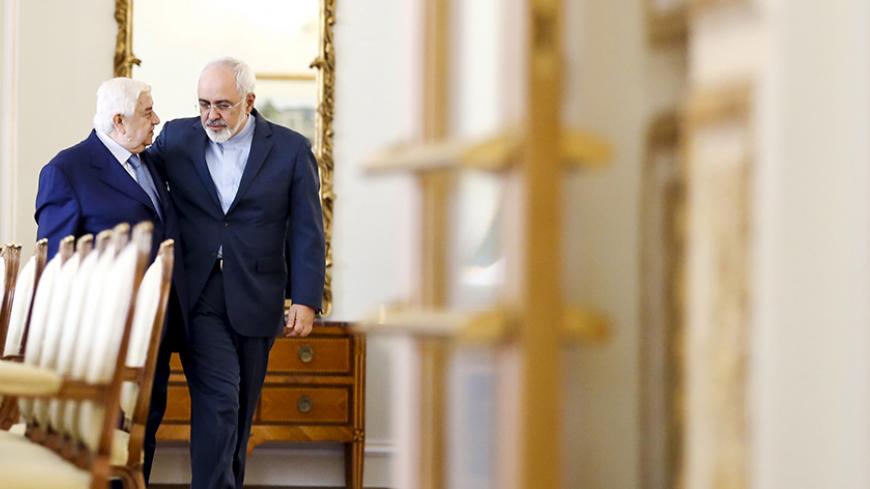 Iranian Foreign Minister Mohammad Javad Zarif (R) and his Syrian counterpart Walid al-Moualem walk before they start a meeting in Tehran August 5, 2015. Syrian Foreign Minister Walid al-Moualem arrived in Tehran on Tuesday for talks with officials from allies Iran and Russia that are expected to focus on efforts to end the civil war in his country. REUTERS/Raheb Homavandi/TIMA ATTENTION EDITORS - THIS PICTURE WAS PROVIDED BY A THIRD PARTY. REUTERS IS UNABLE TO INDEPENDENTLY VERIFY THE AUTHENTICITY, CONTENT,
