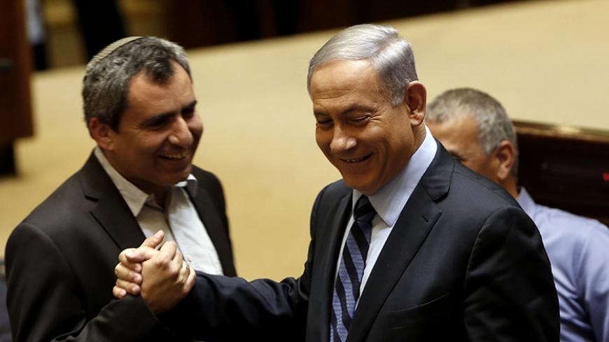 Israeli Prime Minister Benjamin Netanyahu (C) talks with Likud Knesset member Ze'ev Elkin (L) during a meeting at the parliament, the Knesset, in Jerusalem, on May 13, 2015, to vote on a bill to increase the number of ministers permitted. Netanyahu's fledgling coalition passed its first test in a deeply divided parliament when it passed the bill by 61 votes to 59. AFP PHOTO / GALI TIBBON        (Photo credit should read GALI TIBBON/AFP/Getty Images)