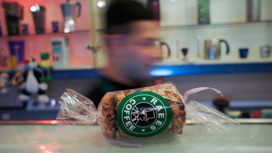 A product showing the Raees Coffee logo is seen on the counter at a branch of the coffee chain in central Tehran February 5, 2011. In a country where there are no bars, as alcohol is banned, Tehran's Raees Coffee chain has proved popular since its first cafe opened in December 2001, offering both a modern environment, complete with wireless Internet access, and - a first in Iran - takeaway coffee. Many other coffee shops have sprung up in Iran's major cities where, until recently, tea was the beverage of ch