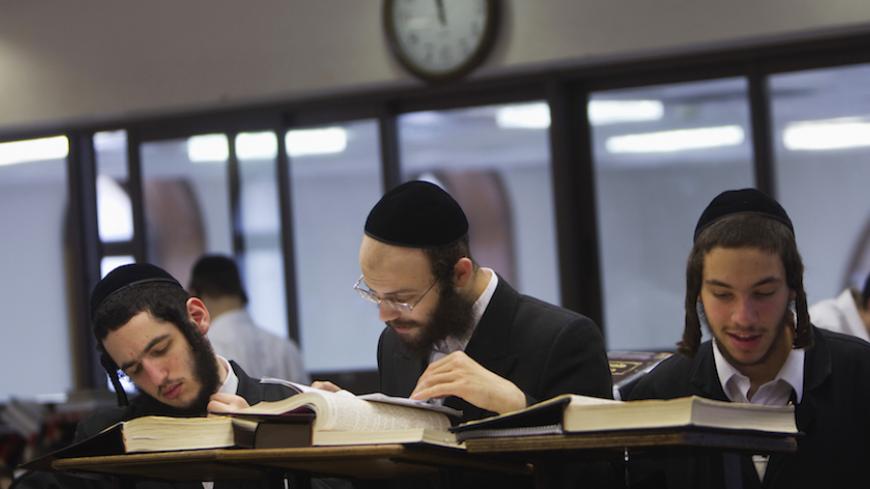 Ultra-Orthodox Jewish men study at Jerusalem's Mir Yeshiva, the largest Jewish seminary in Israel July 4, 2012. The ultra-Orthodox Jews have gone from being a tiny minority in Israel's mostly secular society to its fastest-growing sector, now about 10 percent of the 7.8 million population. They are exempt from military duty in Israel but draft deferments and state subsidies for the ultra-Orthodox have become a divisive political issue in Israel, where the government must decide a new law by August to ensure