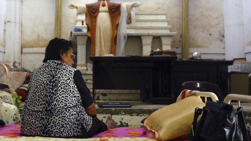 An Iraqi Christian woman fleeing the violence in the Iraqi city of Mosul, sits inside the Sacred Heart of Jesus Chaldean Church in Telkaif near Mosul, in the province of Nineveh, July 20, 2014. The head of Iraq's largest church said on Sunday that Islamic State militants who drove Christians out of Mosul were worse than Mongol leader Genghis Khan and his grandson Hulagu who ransacked medieval Baghdad. Chaldean Catholic Patriarch Louis Raphael Sako led a wave of condemnation for the Sunni Islamists who deman