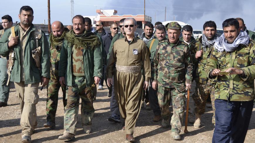 Kirkuk Governor Najmaldin Karim (C) walks with Kurdish peshmerga officers near Khabbaz oilfield, in the outskirts of Kirkuk February 1, 2015. Iraqi Kurdish forces on Sunday found and freed workers who had gone missing a day earlier when Islamic State insurgents seized a small crude oil station near the northern city of Kirkuk, the provincial governor and a provincial councilman said. Picture taken February 1, 2015. REUTERS/Stringer (IRAQ - Tags: CIVIL UNREST CRIME LAW POLITICS ENERGY CONFLICT) - RTR4NVVJ