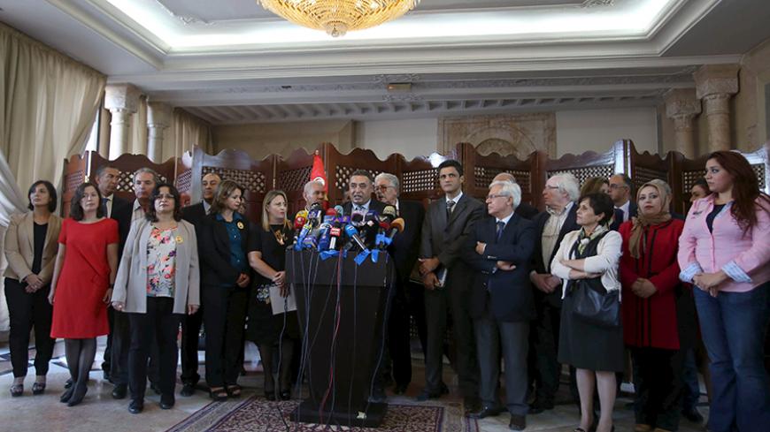 Members of the Tunisian parliament of Nidaa Tounes party gather during a news conference in Tunis, Tunisia November 9, 2015. Thirty two Tunisian lawmakers accused President Beji Caid Essebsi's son of meddling and resigned from the ruling party bloc in parliament on Monday, allowing Islamist rivals to become the largest party. "We decided to resign from the party's bloc today after the refusal to hold an executive committee meeting, which is the only legitimate structure of the party," Hassouna Nasfi, one of
