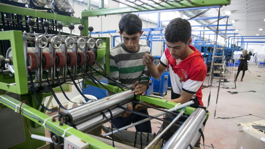 Palestinians work at a textile factory in the Industrial Park of the West Bank Jewish settlement of Barkan, southwest of Nablus November 8, 2015. Few issues have caused more friction between Israel and the European Union than EU plans to impose labeling on goods produced in Jewish settlements on occupied land. And if Israel is right about the timing, the tensions could get worse. Picture taken November 8, 2015. REUTERS/Baz Ratner - RTS6C3O
