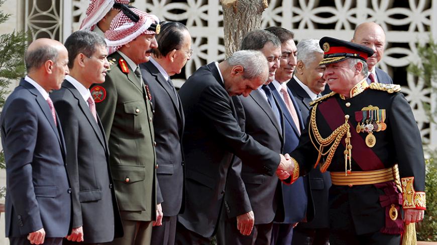 Jordan's King Abdullah (R) shakes hands as he arrives for the opening of the third ordinary session of the 17th Parliament in Amman, Jordan, November 15, 2015. REUTERS/Muhammad Hamed - RTS75Y0