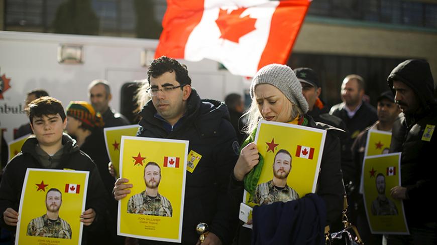 Members of the Kurdish community hold pictures of John Gallagher, a Canadian volunteer fighter and former Canadian forces member who was killed fighting alongside Kurdish forces in Syria against the Islamic State, in Toronto, November 20, 2015.   REUTERS/Mark Blinch  - RTS85W0