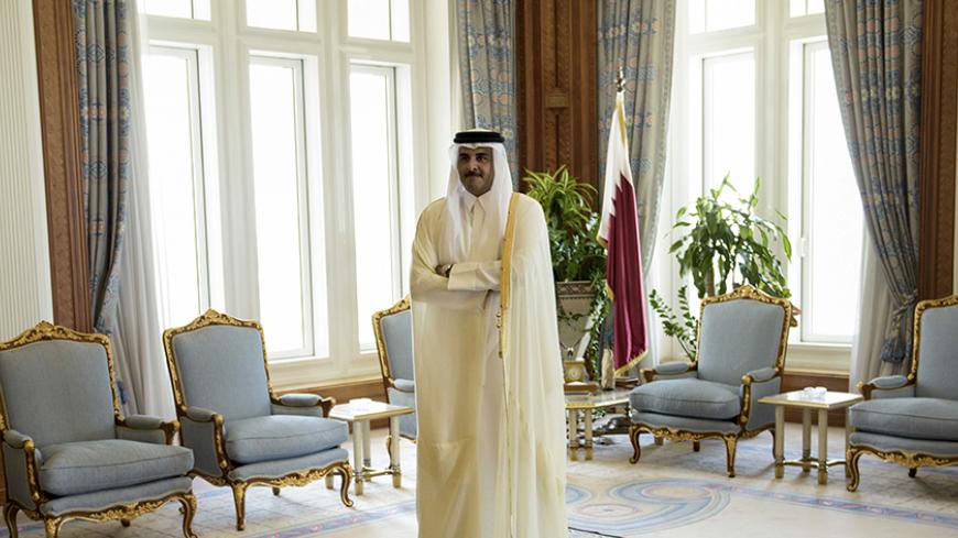 Qatar's Emir Sheikh Tamim bin Hamad al-Thani waits for U.S. Secretary of State John Kerry before their meeting at the Diwan Palace in Doha, August 3, 2015. Kerry is meeting his Gulf Arab counterparts for talks in Qatar as he attempts to ease the concerns of key allies over the Iran nuclear deal. REUTERS/Brendan Smialowski/Pool - RTX1MTEV