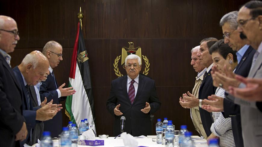 Palestinian President Mahmoud Abbas (C), joins a reading of the Koran prior to a meeting of the Palestinian Liberation Organization (PLO) executive committee in the West Bank city of Ramallah, August 22, 2015. REUTERS/Majdi Mohammed/Pool - RTX1P89U