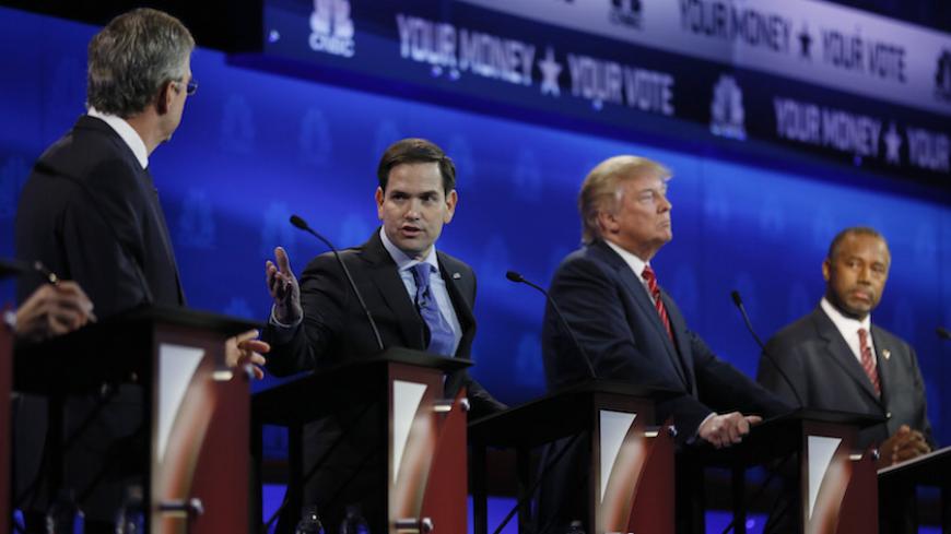 Republican U.S. presidential candidate U.S. Senator Marco Rubio speaks as former Governor Jeb Bush (L), businessman Donald Trump (2nd R) and Dr. Ben Carson (R) listen at the 2016 U.S. Republican presidential candidates debate held by CNBC in Boulder, Colorado, October 28, 2015. REUTERS/Rick Wilking  - RTX1TPZI