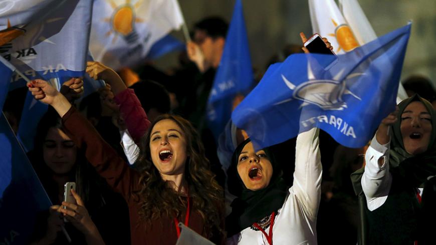 Women wave flags outside the AK Party headquarters in Ankara, Turkey November 1, 2015. Turkish Prime Minister Ahmet Davutoglu described the outcome of a general election which swept his AK Party back to a parliamentary majority on Sunday as a victory for democracy. Picture taken November 1, 2015. REUTERS/Umit Bektas - RTX1UC6Q