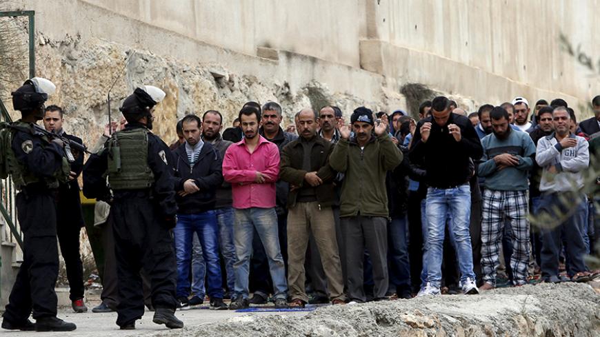 Israeli border police stand guard during Friday prayer outside a mosque in the West Bank city of Hebron November 6, 2015. The Israeli army shot dead two Palestinians on Friday, one an elderly woman accused of trying to run over soldiers in the occupied West Bank and the other a man who took part in a violent Gaza Strip protest, hospital officials said. REUTERS/Mussa Qawasma - RTX1V2BK