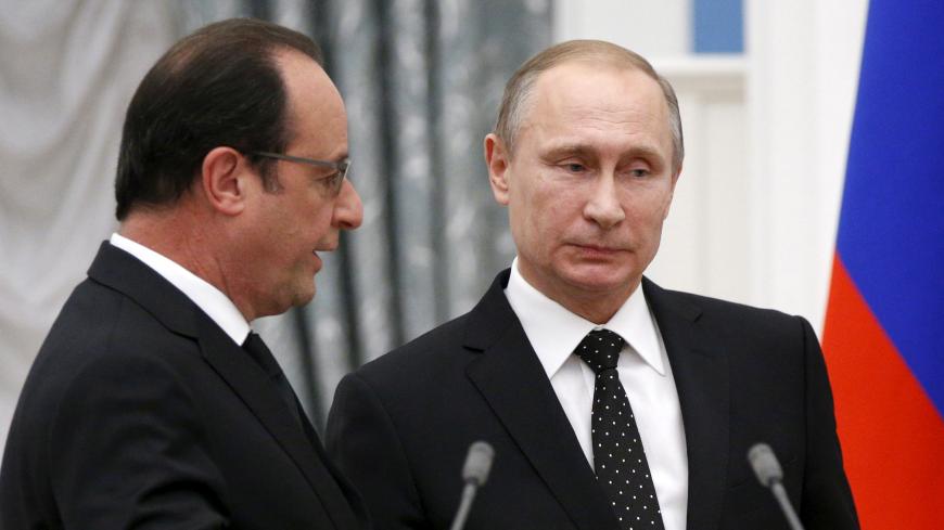 Russia's President Vladimir Putin (R) and his French counterpart Francois Hollande speak after a news conference at the Kremlin in Moscow, Russia, November 26, 2015. France and Russia agreed on Thursday to exchange intelligence on Islamic State and other militant groups in Syria to help improve the effectiveness of their aerial bombing campaigns in the country, French President Francois Hollande said. REUTERS/Alexander Zemlianichenko/Pool  - RTX1W0QV