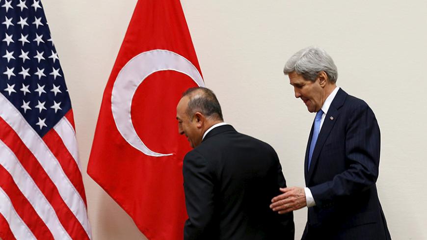 Turkish Foreign Minister Mevlut Cavusoglu (L) meets with U.S. Secretary of State John Kerry alongside NATO ministerial meetings at NATO Headquarters in Brussels, Belgium December 1, 2015. REUTERS/Jonathan Ernst - RTX1WORT