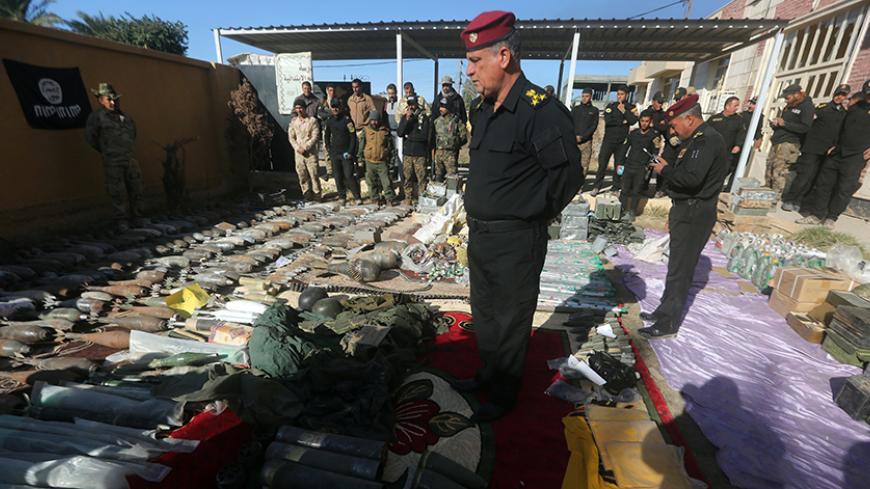 Members of the Iraqi counter-terrorism forces inspect weapons that were found in an arms depot which belonged to Islamic State (IS) group jihadists, in the al-Tameem district of Ramadi, a large city on the Euphrates 100 kilometres (60 miles) west of Baghdad on December 9, 2015. Iraqi forces consolidated newly gained positions in Ramadi, after achieving a breakthrough in their fight against the Islamic State (IS) group by retaking a large part of the city.
 / AFP / AHMAD AL-RUBAYE        (Photo credit should